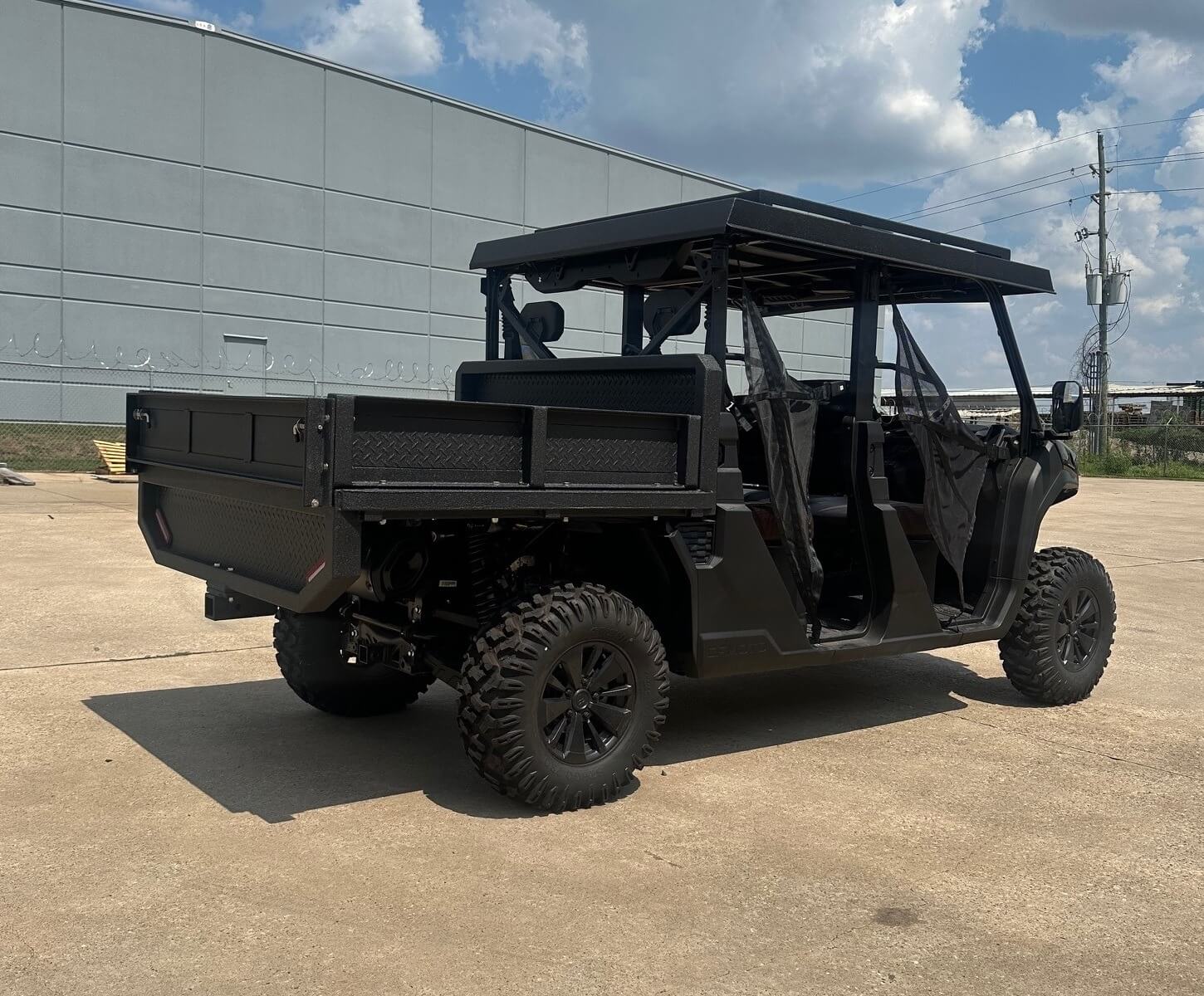CFMOTO UFORCE equipped with a Big Country Outdoors flat bed with sides